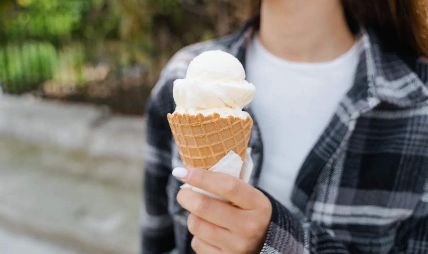 Someone is holding an ice cream.