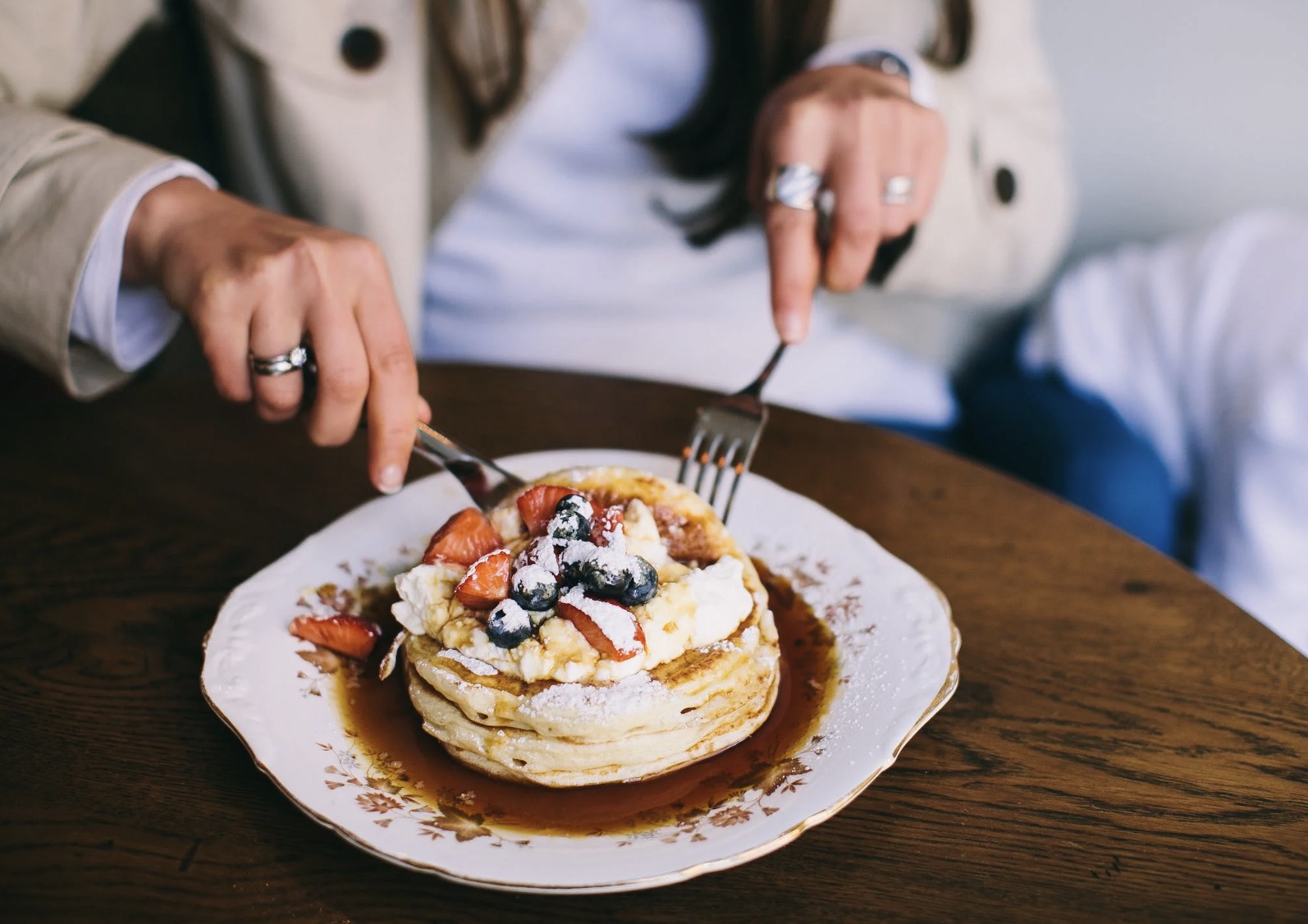 woman cutting pancakes