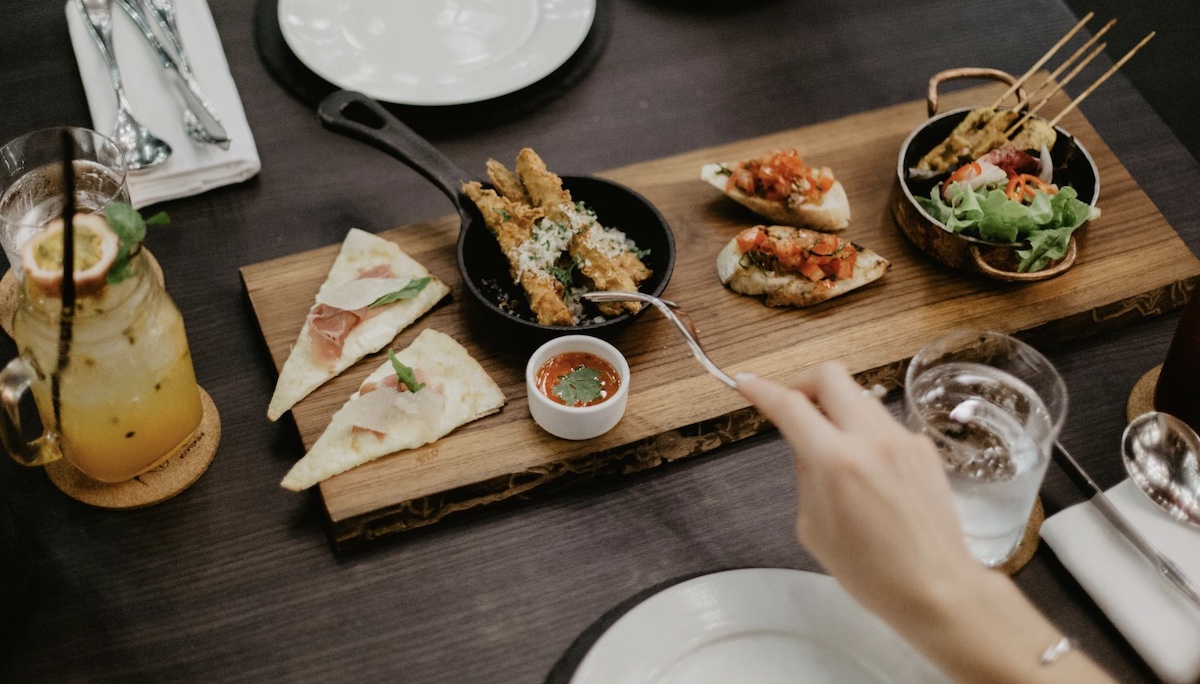 Enjoying food. Image: Pexels - ROMAN ODINTSOV