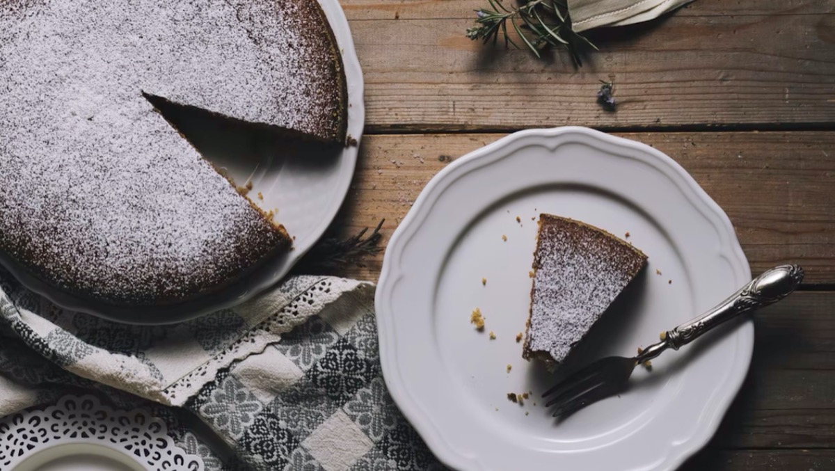 Chocolate cake with a slice cut out. Unsplash - Henry Be