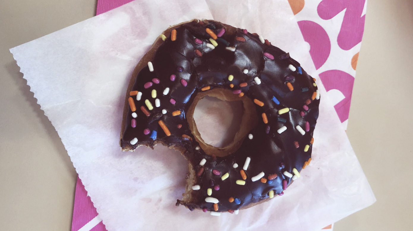 Donut with a bite taken out of it.