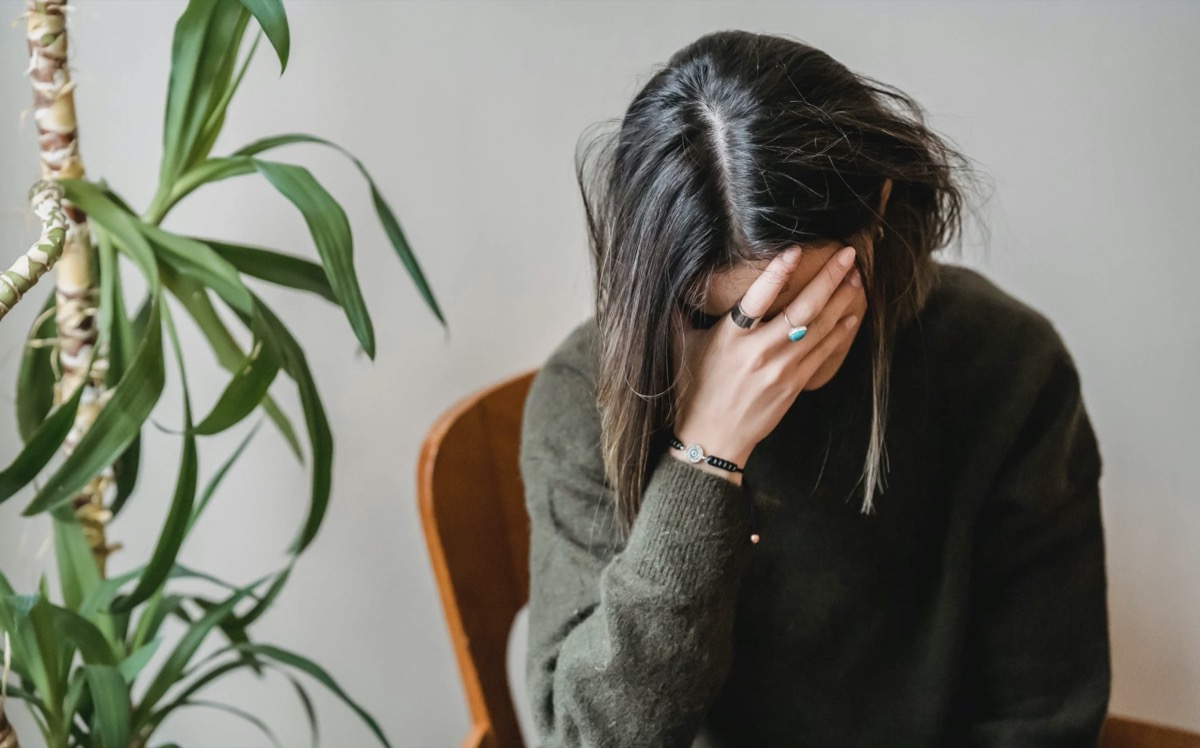 Woman feeling emotional with head down. Image - Pexels: Liza Summer