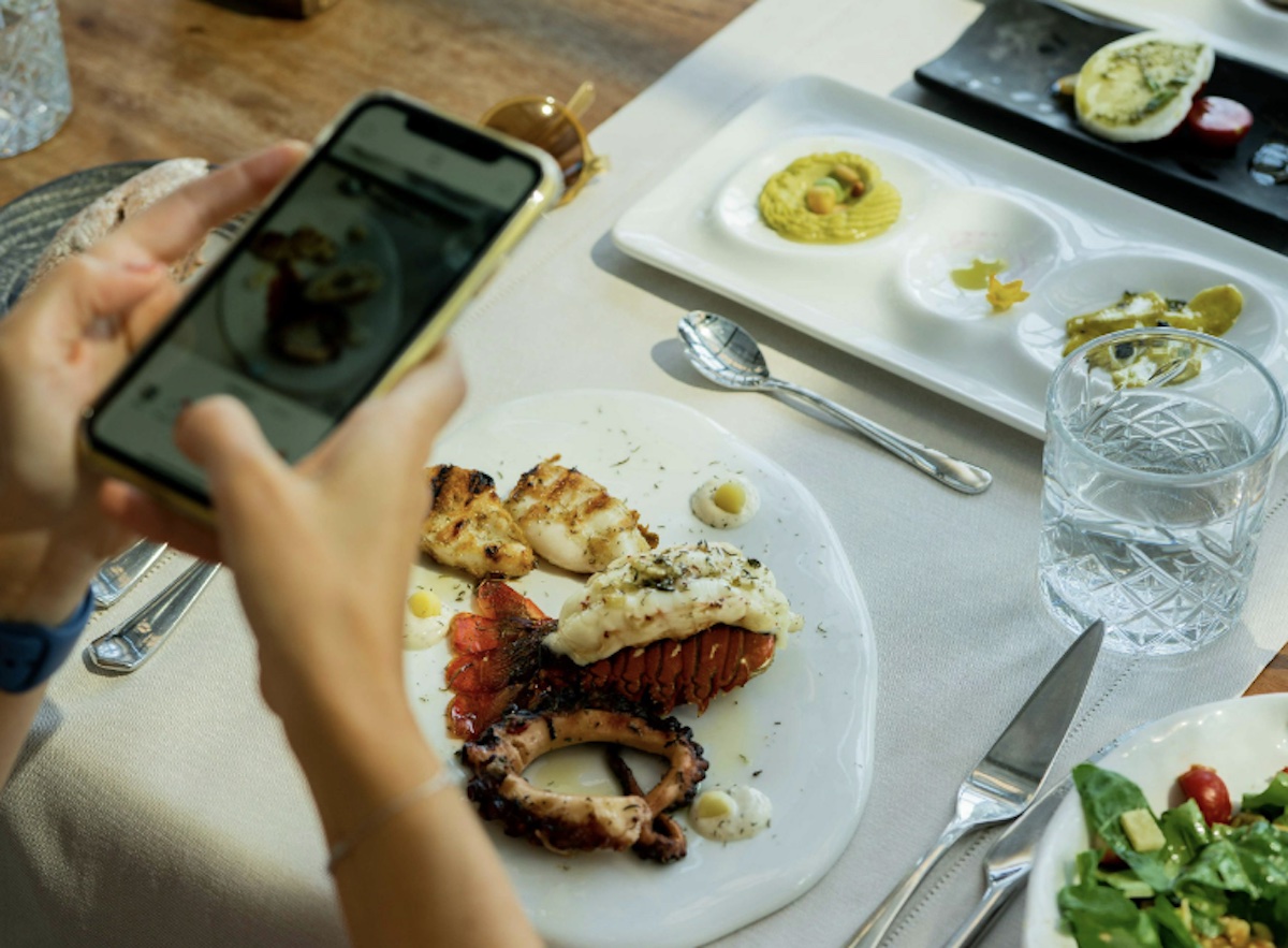 Taking a picture of food. Image: Pexels - Kadir Avşar