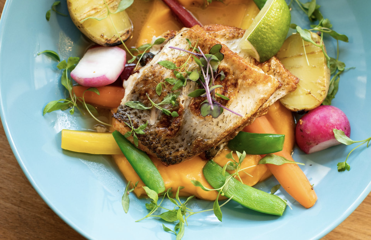 Plate of food with veggies and fish. Image: Pexels - Valeria Boltneva