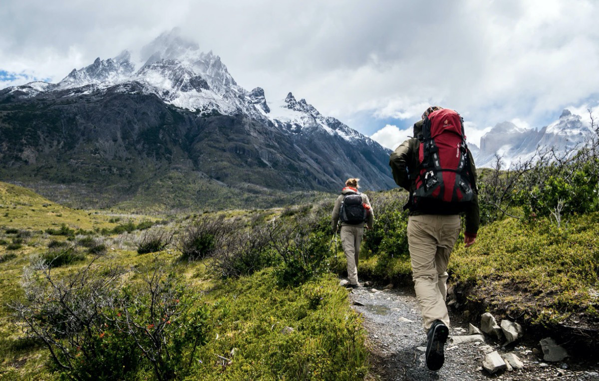 Two individuals climbing a mountain. Unsplash - Toomas Tartes