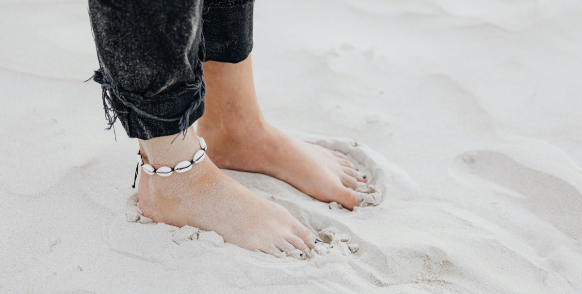 Woman standing in the sand 