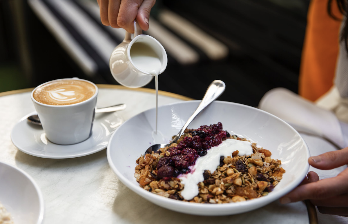 Eating a bowl of cereal and yogurt. Image: Pexels - Maria Bortolotto