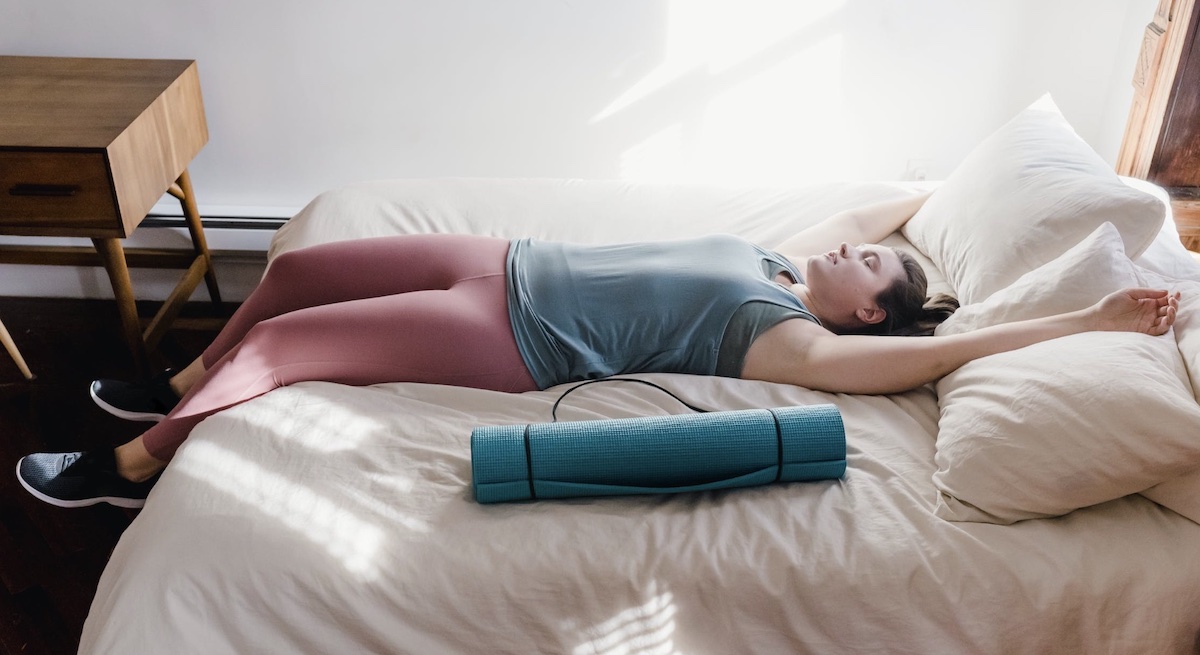Woman sleeping on bed. Image: Pexels - Tim Samuel