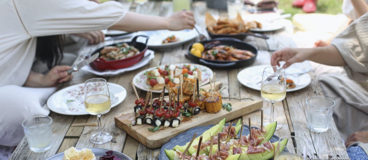 social gathering reaching for food and different appetizers