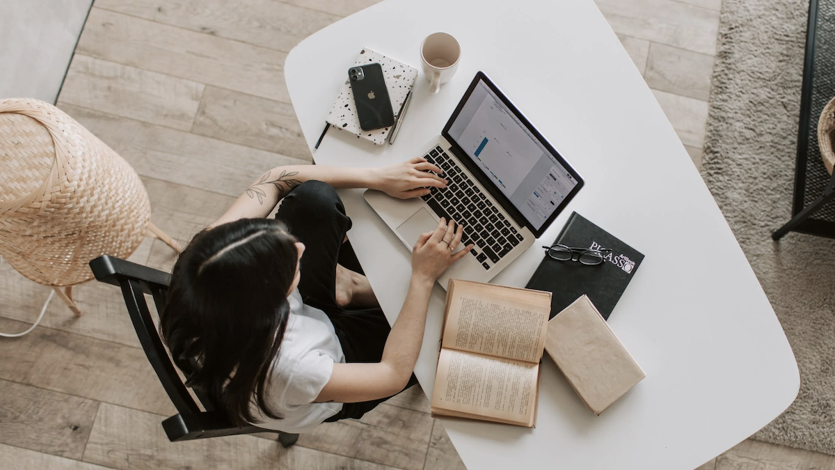 Woman sitting at desk working and studying. 