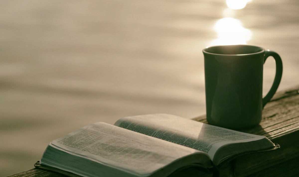 Coffee and reading while on vacation by the beach